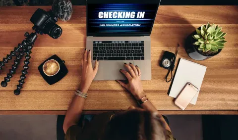 Woman watching IHG Owners association video on laptop